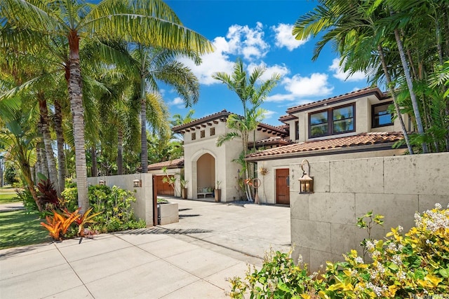 4462 Kahala Ave, Honolulu, HI 96816 - mediterranean / spanish-style house featuring concrete driveway, stucco siding, a garage, and a tile roof