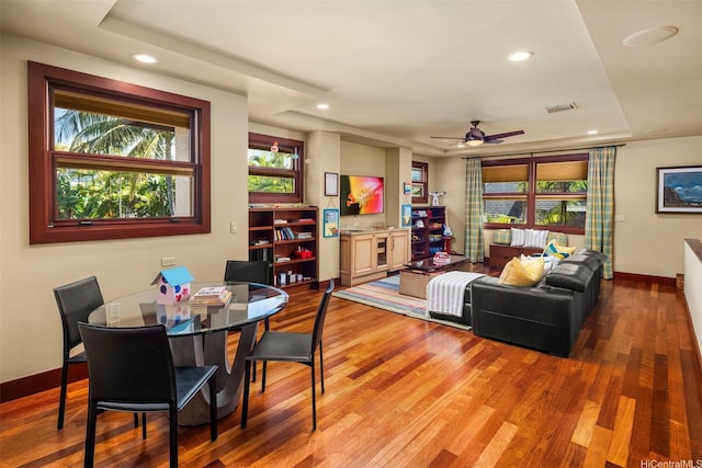 4462 Kahala Ave, Honolulu, HI 96816 - dining space with wood finished floors, a tray ceiling, a ceiling fan, and recessed lighting