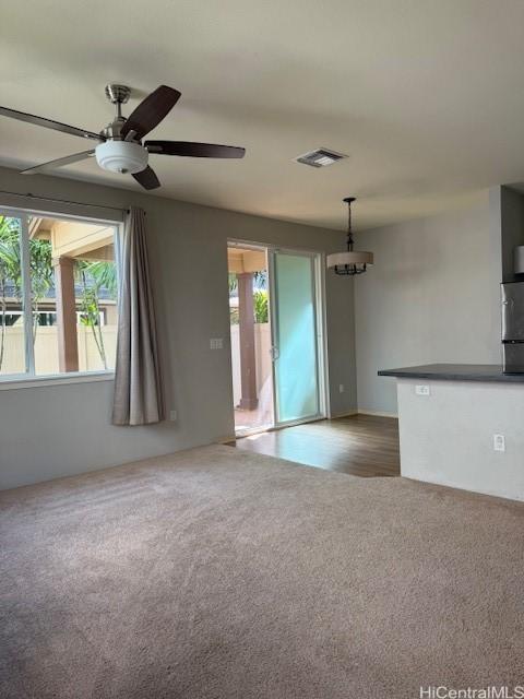 91-1160 Kamakana St Unit 202, Ewa Beach, HI 96706 - unfurnished living room with carpet floors, a ceiling fan, and a chandelier