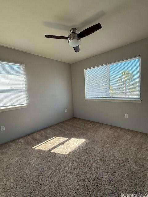 91-1160 Kamakana St Unit 202, Ewa Beach, HI 96706 - empty room with healthy amount of natural light, carpet, and a ceiling fan