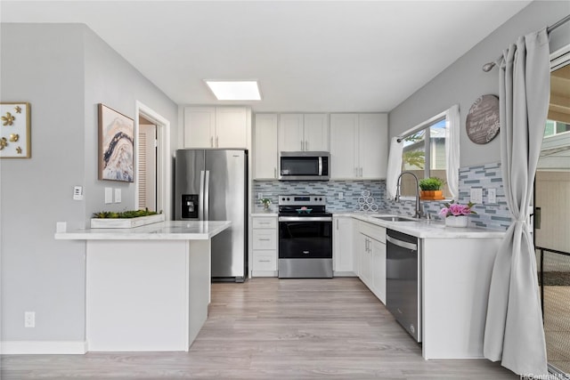 91-1043 Hoomaka St Unit 48, Ewa Beach, HI 96706 - kitchen featuring appliances with stainless steel finishes, a sink, light wood finished floors, and tasteful backsplash