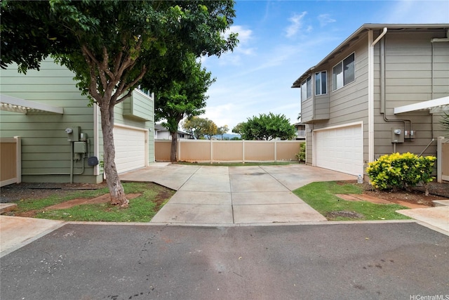 91-1043 Hoomaka St Unit 48, Ewa Beach, HI 96706 - view of yard with driveway, a garage, and fence