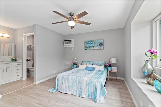 91-1043 Hoomaka St Unit 48, Ewa Beach, HI 96706 - bedroom featuring light wood-style flooring, baseboards, a wall mounted AC, and connected bathroom