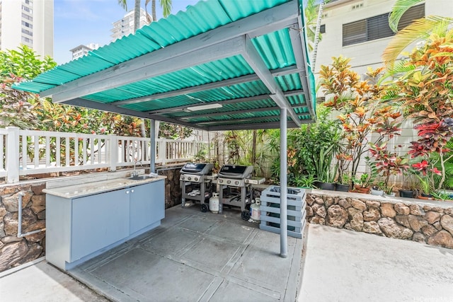 1556 Piikoi St Unit 1802, Honolulu, HI 96822 - view of patio / terrace featuring a sink, a grill, fence, and a detached carport