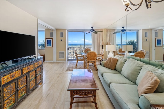 1765 Ala Moana Blvd Unit 790, Honolulu, HI 96815 - living area with floor to ceiling windows, baseboards, ceiling fan, light tile patterned floors, and a water view