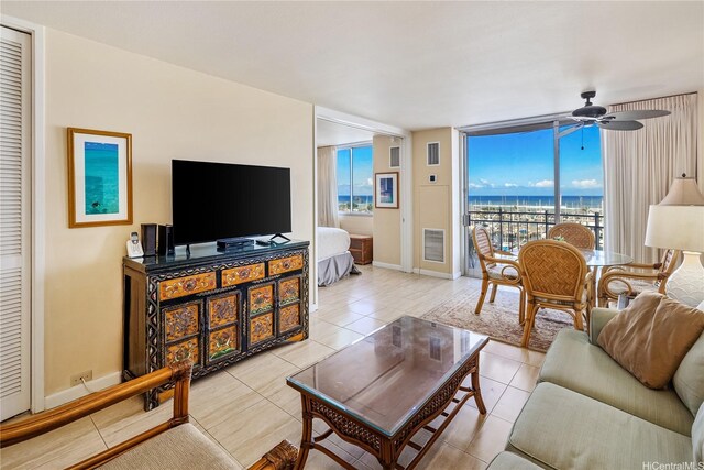 1765 Ala Moana Blvd Unit 790, Honolulu, HI 96815 - living room with ceiling fan, tile patterned floors, baseboards, and floor to ceiling windows