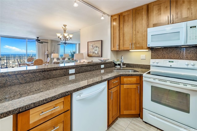 1765 Ala Moana Blvd Unit 790, Honolulu, HI 96815 - kitchen featuring white appliances, a sink, brown cabinets, and dark stone countertops