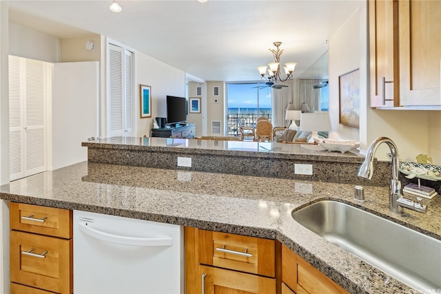 1765 Ala Moana Blvd Unit 790, Honolulu, HI 96815 - kitchen featuring a sink, white dishwasher, a chandelier, open floor plan, and dark stone countertops