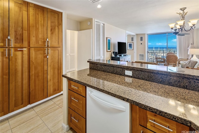 1765 Ala Moana Blvd Unit 790, Honolulu, HI 96815 - kitchen with white dishwasher, open floor plan, brown cabinets, and dark stone counters