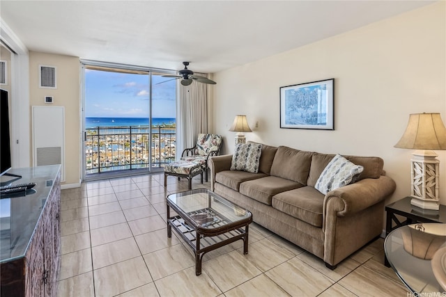 1765 Ala Moana Blvd Unit 1286, Honolulu, HI 96815 - living area with expansive windows, ceiling fan, light tile patterned floors, and a water view