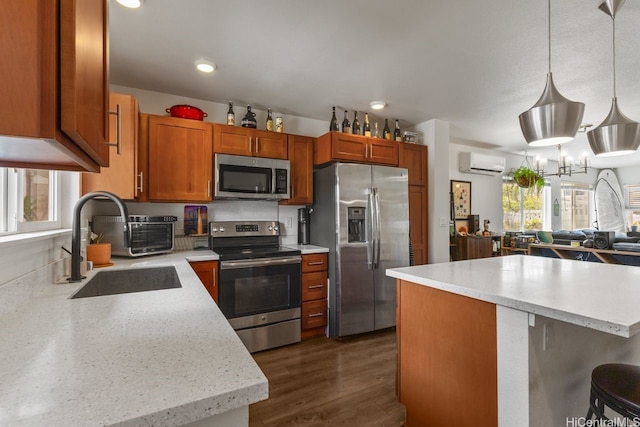 724 Kakala St Unit 2101, Kapolei, HI 96707 - kitchen featuring appliances with stainless steel finishes, an AC wall unit, a sink, light countertops, and pendant lighting
