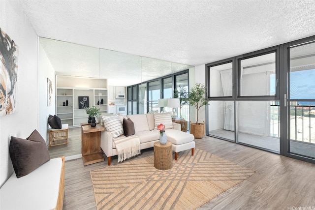 1520 Ward Ave Unit 802, Honolulu, HI 96822 - living area with floor to ceiling windows, a textured ceiling, and wood finished floors