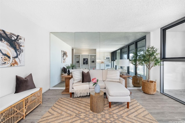 1520 Ward Ave Unit 802, Honolulu, HI 96822 - living room featuring a textured ceiling, wood finished floors, and expansive windows