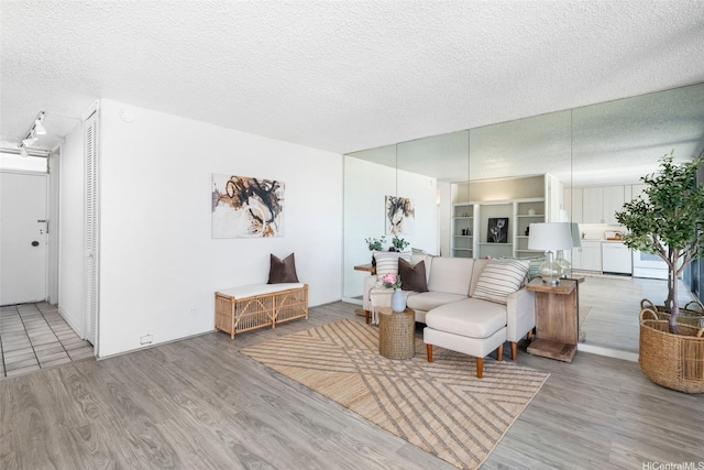 1520 Ward Ave Unit 802, Honolulu, HI 96822 - living room featuring a textured ceiling and light wood-style floors