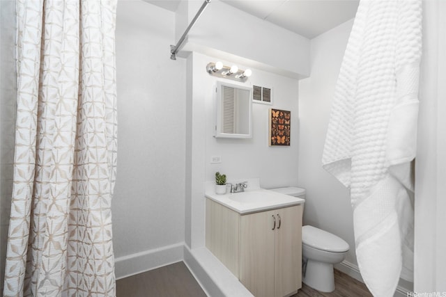 1520 Ward Ave Unit 802, Honolulu, HI 96822 - full bathroom featuring wood finished floors, toilet, vanity, and baseboards