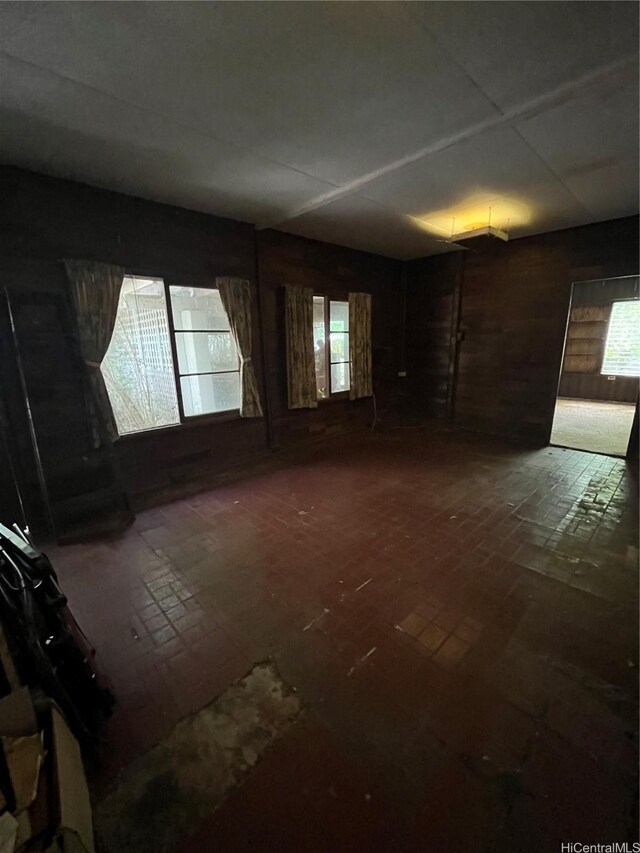 41-24 Hinalea St, Waimanalo, HI 96795 - unfurnished room featuring plenty of natural light, brick patterned flooring, and wooden walls
