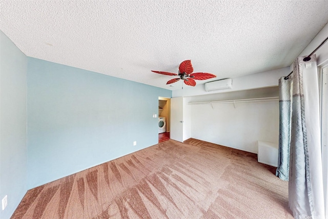 44-3082 Olina St Unit 5/2, Kaneohe, HI 96744 - unfurnished bedroom with washer / dryer, carpet flooring, a wall mounted AC, a textured ceiling, and a ceiling fan