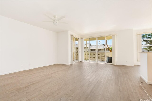 1340 Moanalualani Pl Unit 4D, Honolulu, HI 96819 - unfurnished living room featuring light wood-style flooring, a ceiling fan, and baseboards