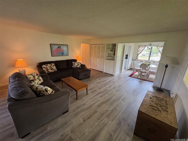 95-146 Kuahelani Ave Unit 131, Mililani, HI 96789 - living room with a textured ceiling and wood finished floors