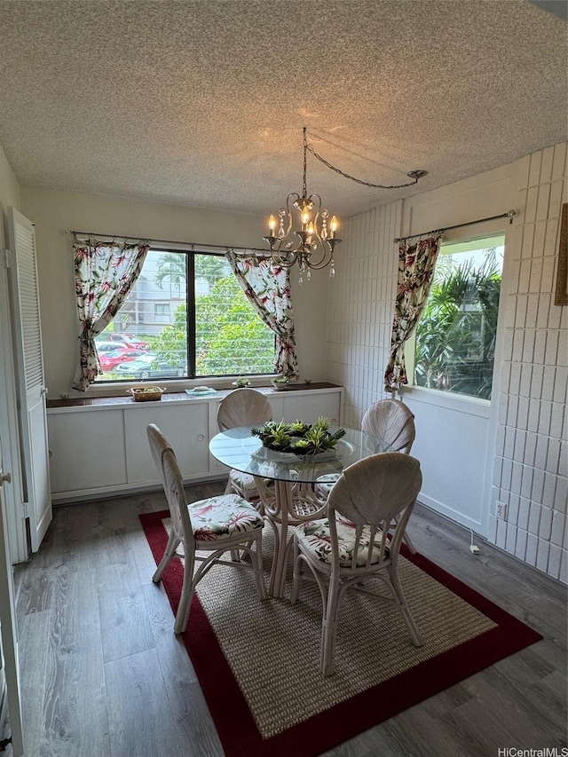 95-146 Kuahelani Ave Unit 131, Mililani, HI 96789 - dining room with wood finished floors, a textured ceiling, and a chandelier