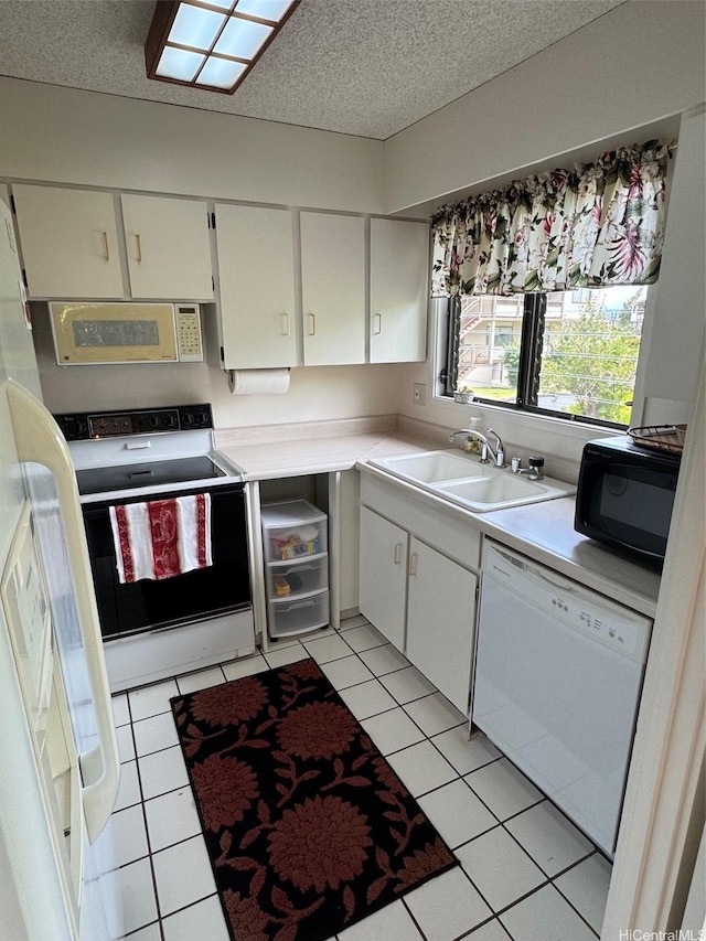 95-146 Kuahelani Ave Unit 131, Mililani, HI 96789 - kitchen featuring a sink, white appliances, light countertops, white cabinetry, and light tile patterned floors
