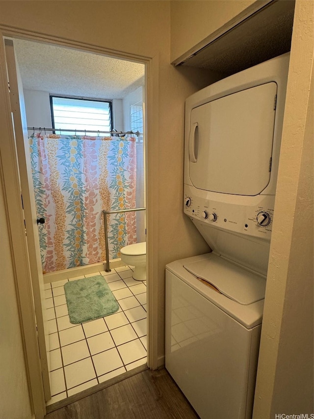 95-146 Kuahelani Ave Unit 131, Mililani, HI 96789 - laundry area with stacked washer / dryer and wood finished floors
