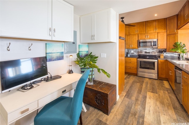 53-797 Kamehameha Hwy, Hauula, HI 96717 - kitchen with appliances with stainless steel finishes, dark wood-type flooring, brown cabinets, a sink, and decorative backsplash