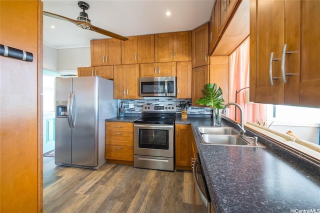 53-797 Kamehameha Hwy, Hauula, HI 96717 - kitchen with appliances with stainless steel finishes, a sink, brown cabinets, dark wood-type flooring, and dark countertops