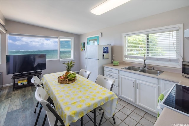 53-797 Kamehameha Hwy, Hauula, HI 96717 - kitchen with a sink, freestanding refrigerator, range with electric stovetop, white cabinetry, and healthy amount of natural light