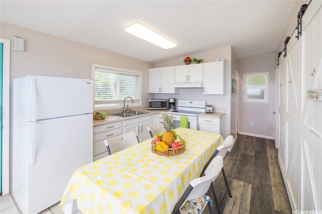 53-797 Kamehameha Hwy, Hauula, HI 96717 - kitchen with white appliances, a sink, a barn door, light countertops, and dark wood-style flooring