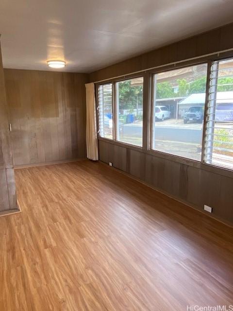 94-549 Pilimai St, Waipahu, HI 96797 - empty room with light wood-style floors, plenty of natural light, and wood walls