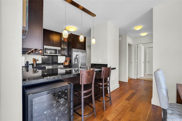 1189 Waimanu St Unit 1606, Honolulu, HI 96814 - kitchen featuring stainless steel appliances, wine cooler, dark brown cabinets, dark wood-style flooring, and a peninsula