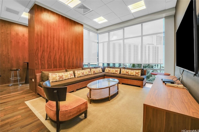 1189 Waimanu St Unit 1606, Honolulu, HI 96814 - living area with wood finished floors, wooden walls, and a drop ceiling