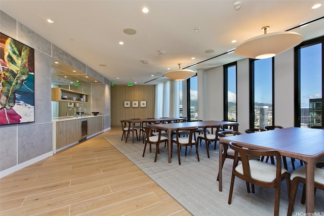 987 Queen St Unit 3404, Honolulu, HI 96814 - dining room featuring light wood-style floors, floor to ceiling windows, recessed lighting, and beverage cooler