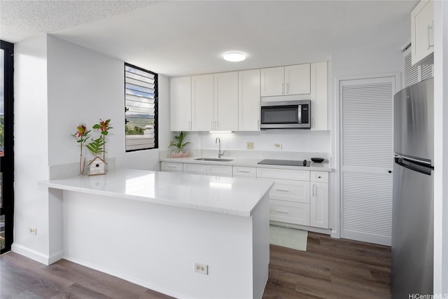 3070 Ala Ilima St Unit 306, Honolulu, HI 96818 - kitchen with appliances with stainless steel finishes, a sink, dark wood-type flooring, a peninsula, and white cabinetry