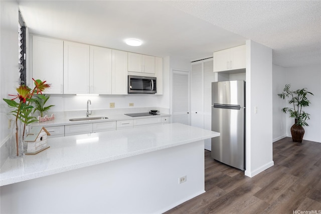 3070 Ala Ilima St Unit 306, Honolulu, HI 96818 - kitchen featuring appliances with stainless steel finishes, a sink, white cabinetry, and dark wood-type flooring
