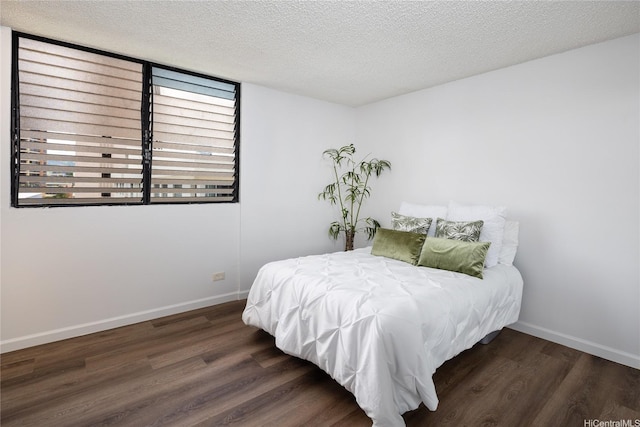 3070 Ala Ilima St Unit 306, Honolulu, HI 96818 - bedroom featuring wood finished floors, baseboards, and a textured ceiling