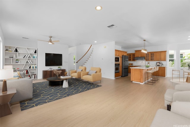 91-1023 Kaikoele St, Ewa Beach, HI 96706 - living area featuring a ceiling fan, light wood finished floors, stairway, and recessed lighting