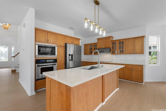 91-1023 Kaikoele St, Ewa Beach, HI 96706 - kitchen with black appliances, a sink, light wood-style floors, and brown cabinets