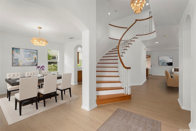 91-1023 Kaikoele St, Ewa Beach, HI 96706 - dining area featuring arched walkways, stairway, wood finished floors, baseboards, and recessed lighting