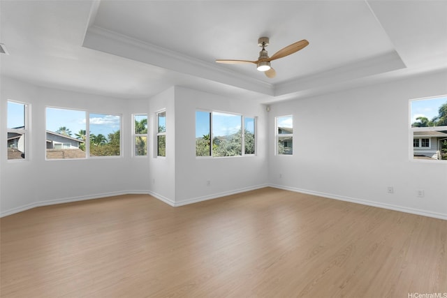 91-1023 Kaikoele St, Ewa Beach, HI 96706 - spare room with a raised ceiling, crown molding, light wood-style flooring, a ceiling fan, and baseboards
