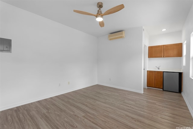 91-1023 Kaikoele St, Ewa Beach, HI 96706 - unfurnished living room featuring light wood-style floors, a wall unit AC, ceiling fan, baseboards, and recessed lighting