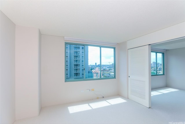 1314 Kalakaua Ave Unit 903, Honolulu, HI 96826 - unfurnished bedroom with carpet, a closet, and a city view