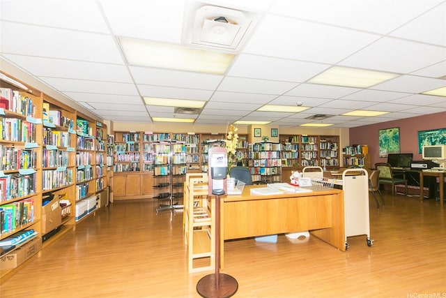 1314 Kalakaua Ave Unit 903, Honolulu, HI 96826 - home office featuring bookshelves, a drop ceiling, and light wood-style floors