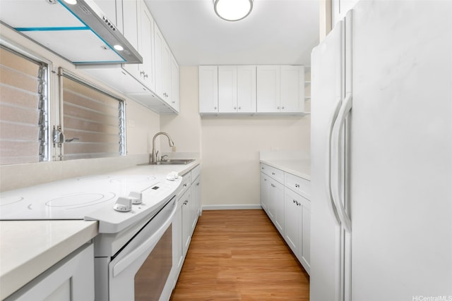 3020 Ala Napuaa Pl Unit 103, Honolulu, HI 96818 - kitchen with white appliances, a sink, baseboards, and white cabinetry