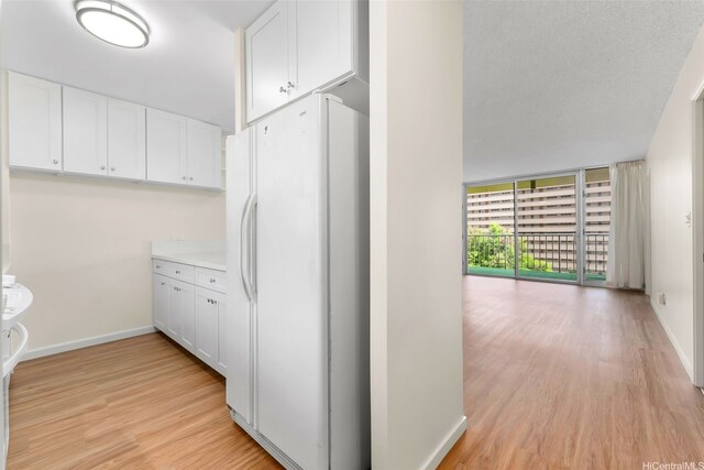 3020 Ala Napuaa Pl Unit 103, Honolulu, HI 96818 - hallway with light wood-type flooring and baseboards