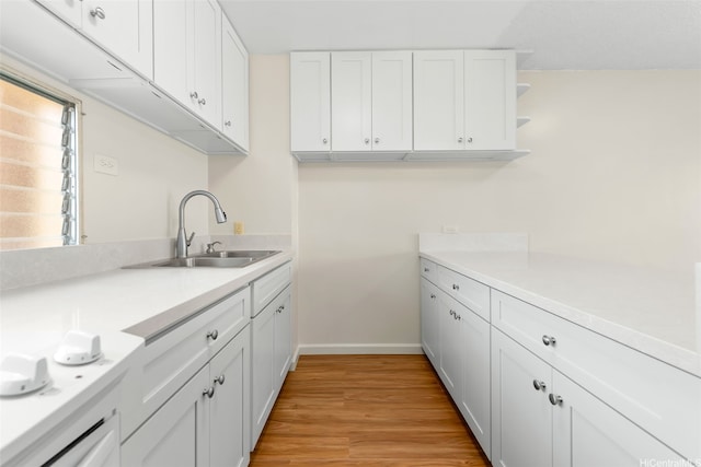 3020 Ala Napuaa Pl Unit 103, Honolulu, HI 96818 - kitchen featuring a sink, white cabinetry, light wood-type flooring, light countertops, and open shelves