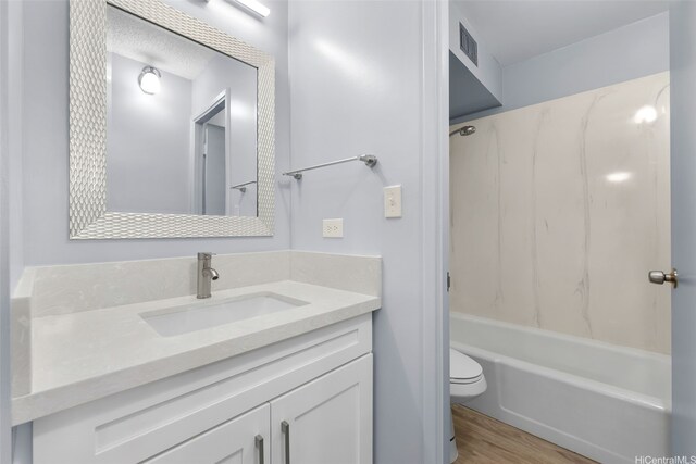 3020 Ala Napuaa Pl Unit 103, Honolulu, HI 96818 - full bathroom featuring wood finished floors, toilet, vanity, and bathing tub / shower combination