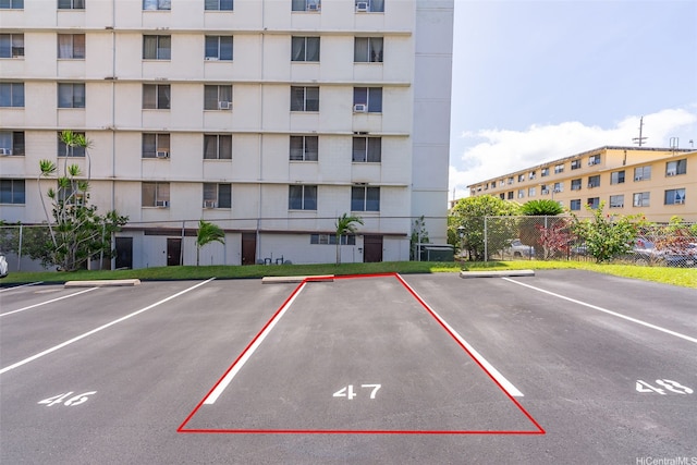 3020 Ala Napuaa Pl Unit 103, Honolulu, HI 96818 - view of apartment building / complex with fence and uncovered parking