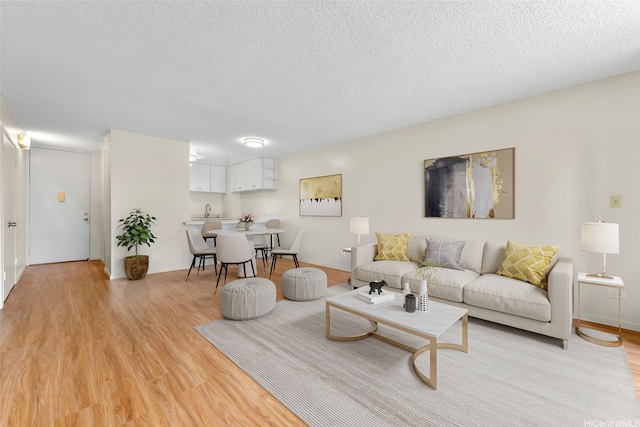 3020 Ala Napuaa Pl Unit 103, Honolulu, HI 96818 - living room featuring light wood-style flooring and a textured ceiling
